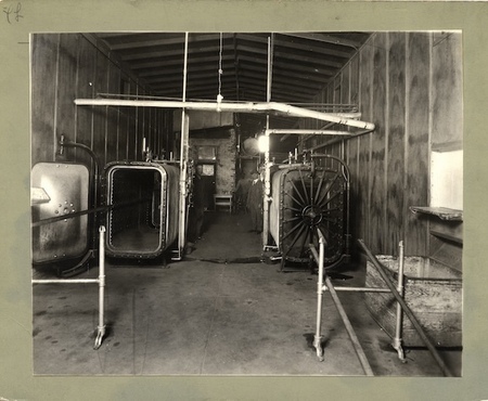"Quarantine Station, El Paso, Texas. View of steam sterilizers in sterilizing room. Note aperture for passing out clothes and box to receive same (right front). Similar opening and box on the other side is not shown in the picture. This is a double plant so that if one unit is closed down for repairs, the work may be continued uninterruptedly."