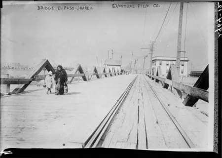 A woman and child cross the international bridge between El Paso and Juarez